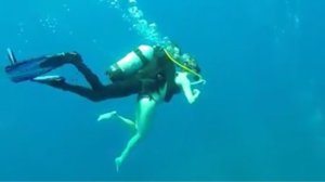 Scuba Diver Piggybacks Tourist To The MS Zenobia 